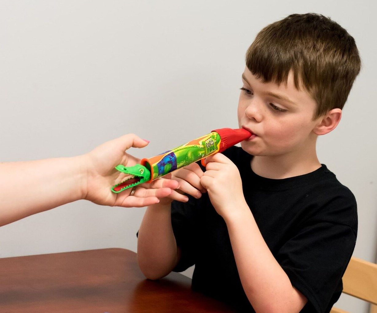 A child blowing on a toy representing PROMPT© Intervention therapy offered by South Shore Therapies in Southern MA