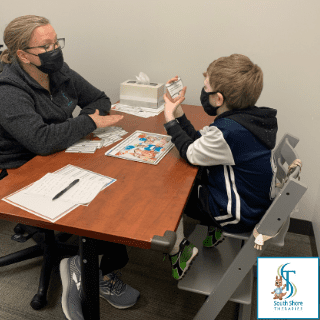 A speech therapist working with a kid in Hingham, MA