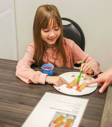 Therapist assisting a child with developmental activities at South Shore Therapies