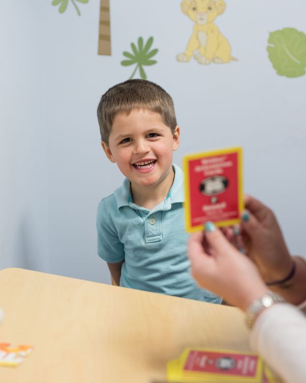 A child working with flashcards representing speech therapy offered by feeding therapy provider South Shore Therapies in Southern MA 