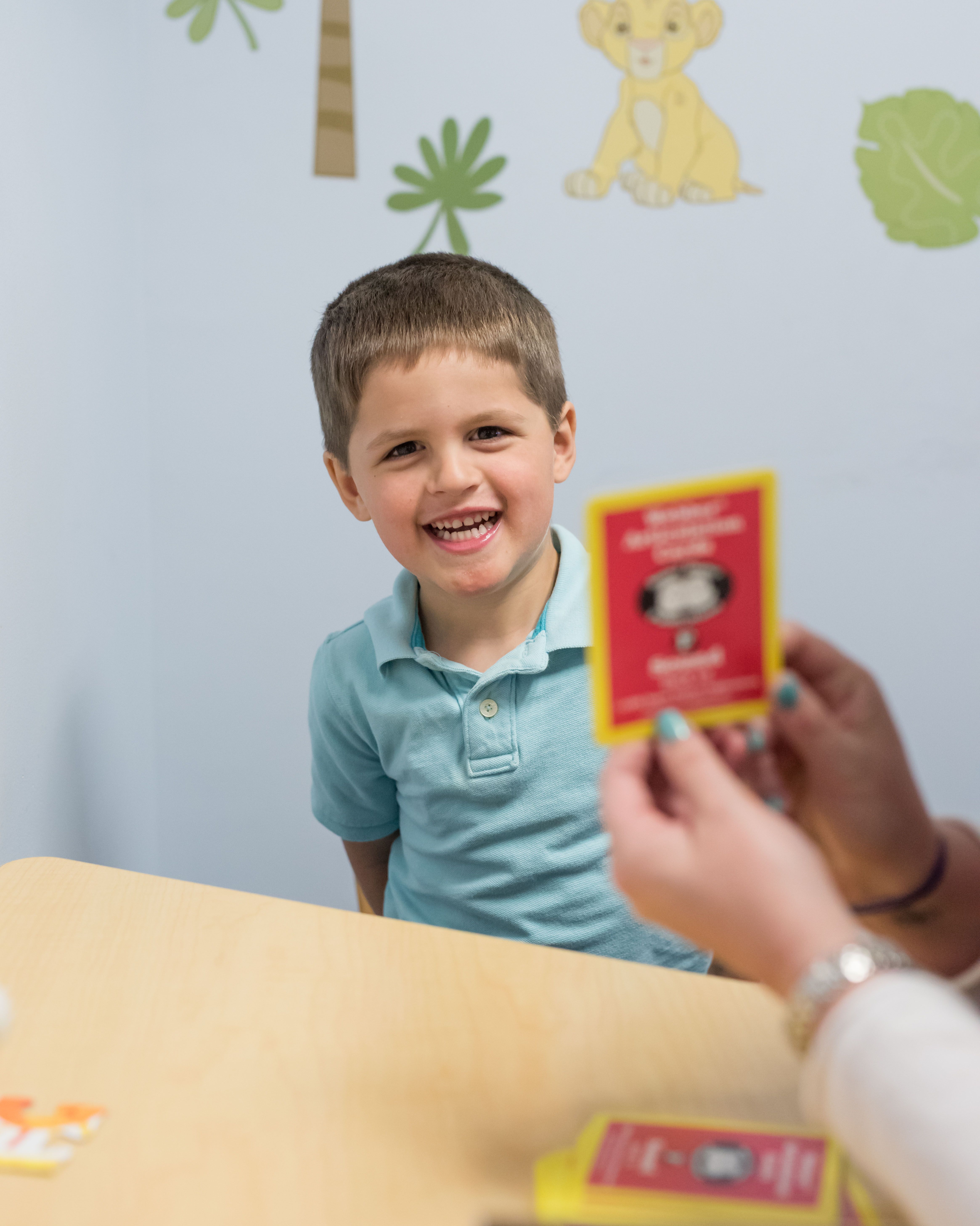 A child working with flashcards representing speech therapy offered by feeding therapy provider South Shore Therapies in Southern MA 
