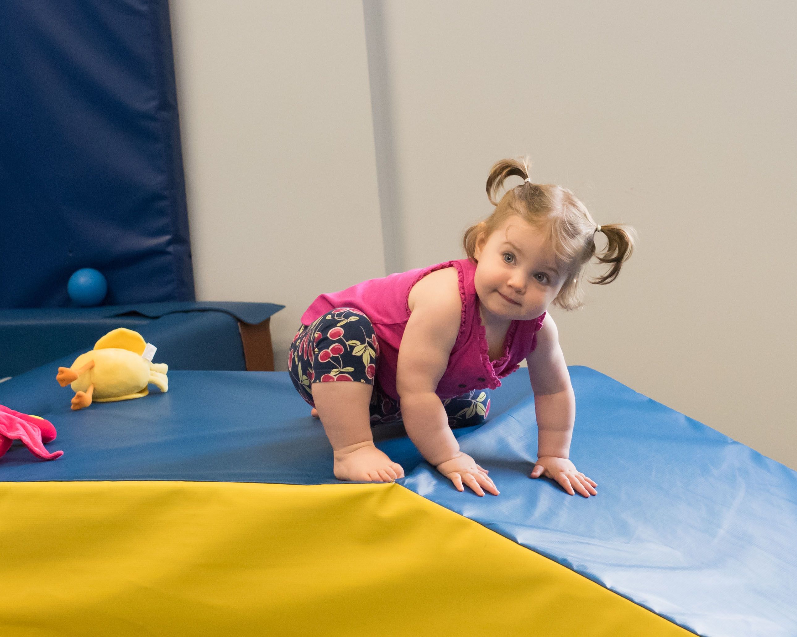 A toddler on a ramp representing sensory integration offered by sensory integration therapy clinic South Shore Therapies in Southern MA