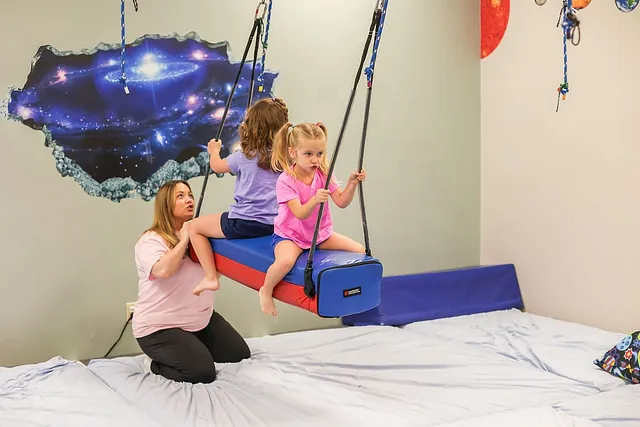 A child enjoying a creative activity with support at South Shore Therapies 