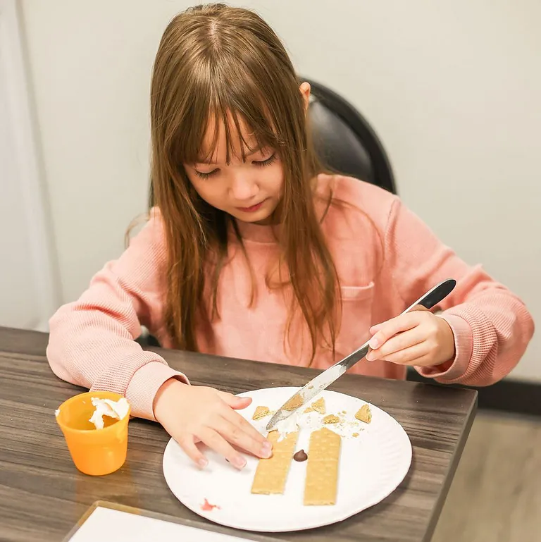 The therapist is assisting a child with developmental activities at South Shore Therapies in Norwood, Hingham, and surrounding areas.  